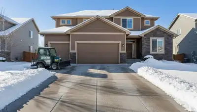 Cleared residential driveway after expert snow removal by Chop Chop Landscaping in Thornton, CO